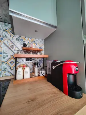 a kitchen with a red mixer on a counter at La Muciara - Best Hospitality in Palermo