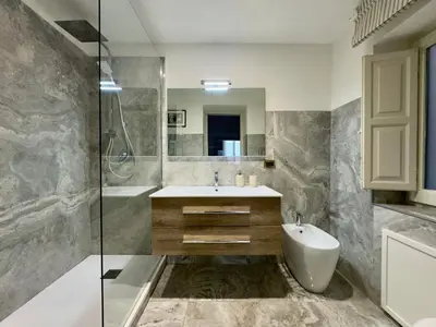 a bathroom with a sink and a shower and a tub at Casa Faidda in Palermo