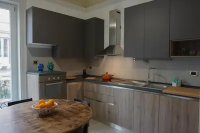 a kitchen with a table with a bowl of oranges on it at Casa Faidda in Palermo