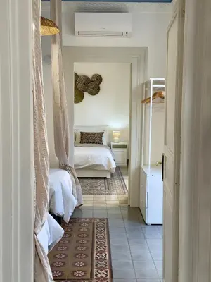 a room with a bedroom with a bed and a rug at Casa Faidda in Palermo
