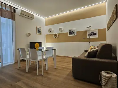 a living room with a table and a couch at Appartamento XII Gennaio 3 in Palermo