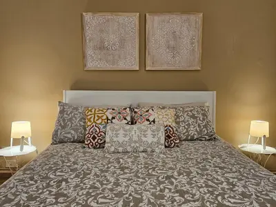 a bedroom with a bed with pillows on it at Appartamento XII Gennaio 3 in Palermo