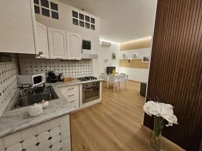 a kitchen with a sink and a counter top at Appartamento XII Gennaio 3 in Palermo