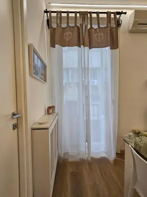 a room with a window with white curtains at Appartamento XII Gennaio 3 in Palermo