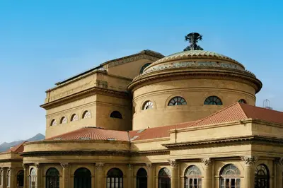a large building with a cross on top of it at Palermo al Massimo in Palermo