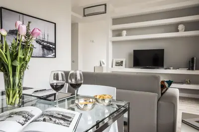 a living room with a glass table and wine glasses at Palermo al Massimo in Palermo
