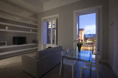 a living room with a glass table and a couch at Palermo al Massimo in Palermo