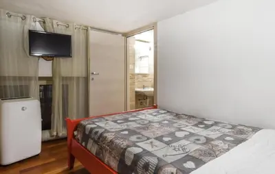 a small bedroom with a bed and a television at Stunning Apartment In Palermo With Wifi in Palermo