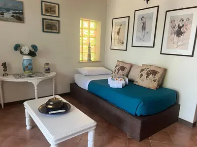 a bedroom with a bed and a coffee table at Casa sul mare Lalu a 20 kl da Palermo e 30 da Cefalu tre camere 9 posti in Santa Flavia
