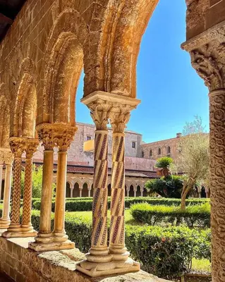 an archway of a building with a garden in the background at Casa Sarina in Monreale