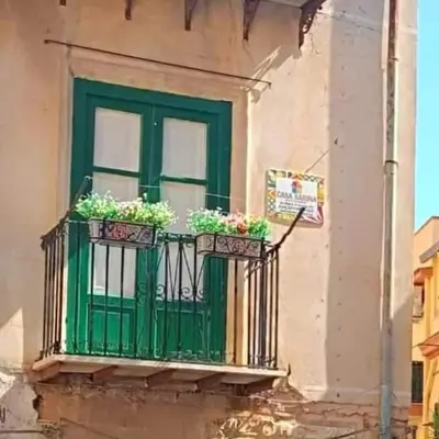 a green window with plants on a balcony at Casa Sarina in Monreale