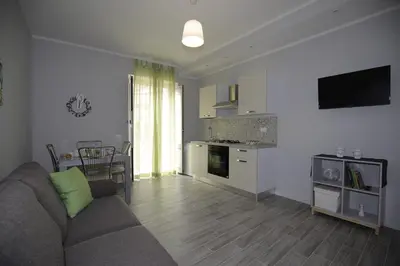 a living room with a couch and a kitchen at Belle Arti in Palermo