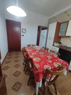 a kitchen with a table with a red table cloth at Casa vacanze balestrate in Balestrate