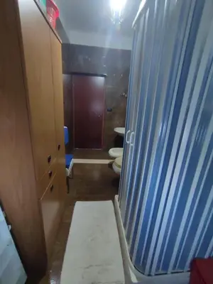 a bathroom with two toilets and a blue door at Casa vacanze balestrate in Balestrate