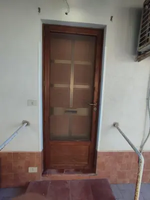 a wooden door in the side of a building at Casa vacanze balestrate in Balestrate