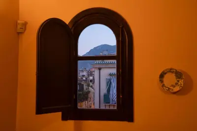 a window with a view of a city at In Torre Palazzo Orioles in Palermo
