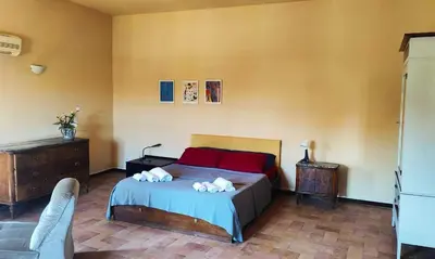 a bedroom with a bed with red pillows at In Torre Palazzo Orioles in Palermo