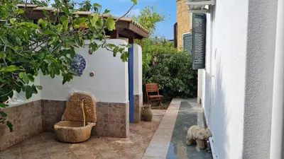 a patio of a house with a table and chairs at Villa Alliata in Campofelice di Roccella