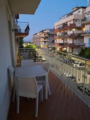 a table and chairs on the balcony of a building at Casa Kennedy in Capaci