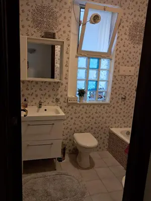 a bathroom with a sink and a toilet and a window at Casa Kennedy in Capaci