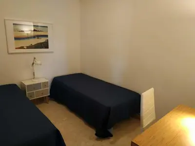 a small bedroom with a bed and a table at Casa vacanze mare Rosa in Castellammare del Golfo