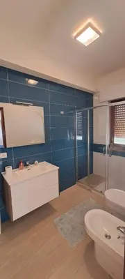 a bathroom with a sink and a toilet and a shower at Casa vacanze mare Rosa in Castellammare del Golfo