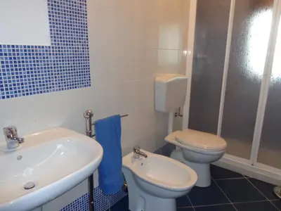 a bathroom with a white toilet and a sink at Casa vacanze mare Rosa in Castellammare del Golfo