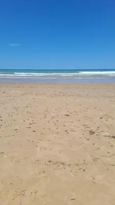 a beach with footprints in the sand and the ocean at Casa vacanze mare Rosa in Castellammare del Golfo