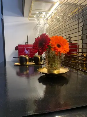 a vase with orange flowers sitting on a table at Ai Chiavettieri Suite in Palermo