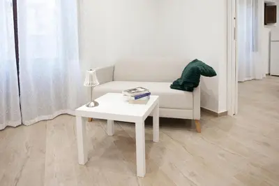 a living room with a white couch and a table at Dominic Luxury House - a 2 passi dalla cattedrale in Palermo