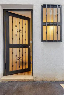 a door with a metal gate in front of a building at Sicily Bed' House in Palermo
