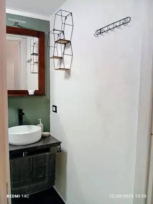 a bathroom with a sink and a mirror at Sicily Bed' House in Palermo