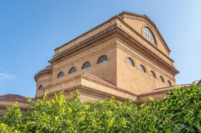 a tall building with a clock on top of it at La Terrazza sul Massimo in Palermo