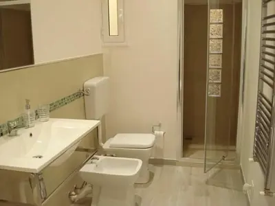 a bathroom with a toilet and a sink and a shower at Appartamento Cantieri-Porto,Palermo in Palermo