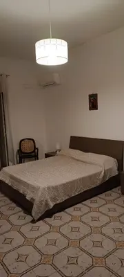 a bedroom with a bed and a light at Casa la B a n d i t a in Palermo
