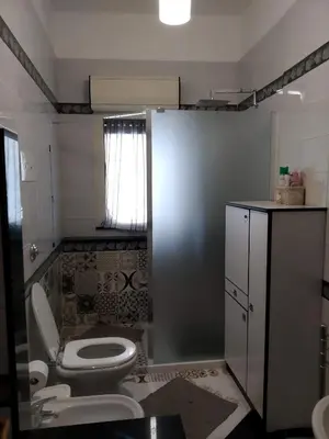 a bathroom with a toilet and a sink at Casa la B a n d i t a in Palermo