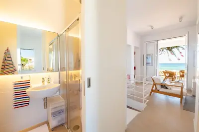 a bathroom with a sink and a glass shower at La Bougainvillea casa vacanze in Alcamo