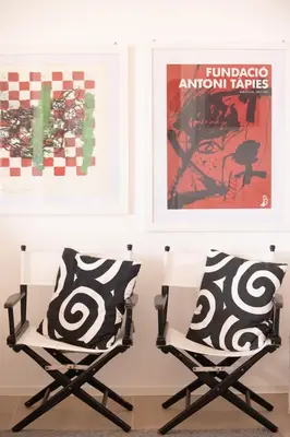 two chairs sitting next to a glass table with pillows at La Bougainvillea casa vacanze in Alcamo