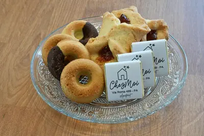 a plate of donuts on a glass plate at Chez Moi in Palermo