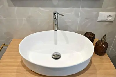 a white sink with a faucet in a bathroom at Chez Moi in Palermo