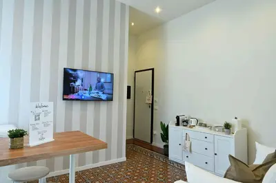 a living room with a tv hanging on a wall at Chez Moi in Palermo
