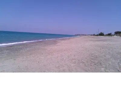 an empty beach with the ocean in the background at Casa delle Salinelle in Lascari