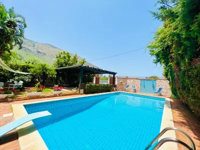 a swimming pool in a yard with a house at Villa Ólea Resort in Carini