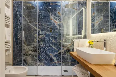 a bathroom with a shower and a white sink at Julia's Boutique Rooms in Palermo