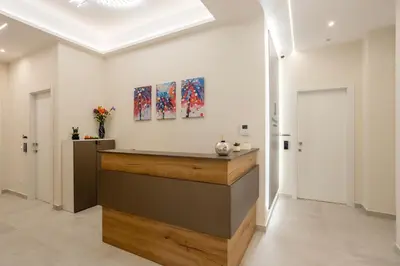 a lobby with a counter with paintings on the wall at Julia's Boutique Rooms in Palermo