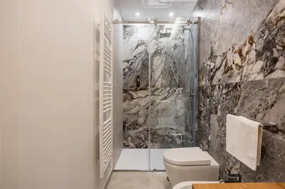 a bathroom with a shower and a toilet at Julia's Boutique Rooms in Palermo