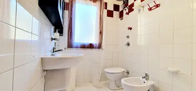 a white bathroom with a sink and a toilet at Green House con piscina privata 7 posti in Macari