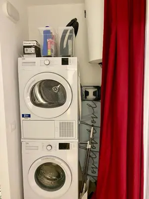 a washer and dryer in a room with a red curtain at La mia Casetta al Politeama in Palermo