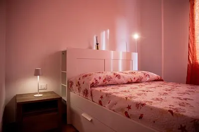 a small bedroom with a bed and a night stand at Villa Stella in Alcamo