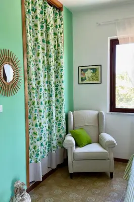 a blue bench sitting next to a wall at B&B Ondamarina in Lascari